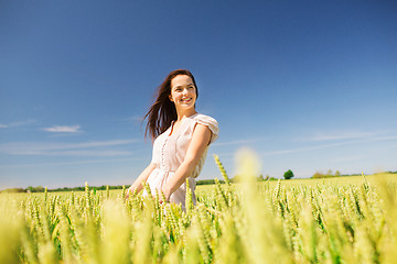Image showing smiling young woman on cereal field