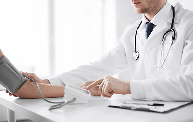 Image showing doctor and patient measuring blood pressure