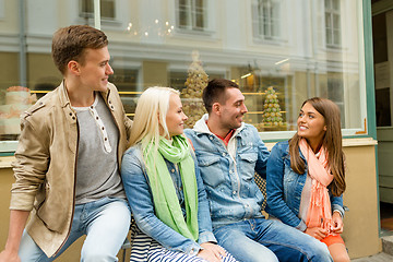 Image showing group of smiling friends walking in the city