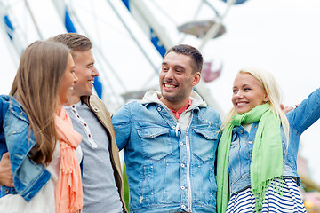 Image showing group of smiling friends in amusement park