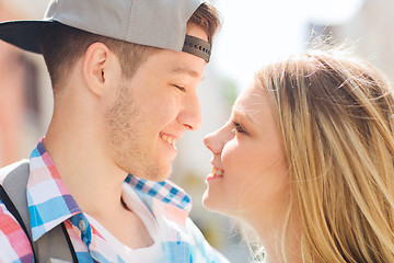 Image showing smiling couple with backpack in city