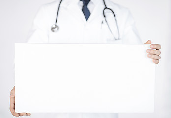 Image showing doctor holding blank white banner