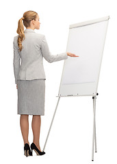 Image showing businesswoman or teacher with whiteboard from back