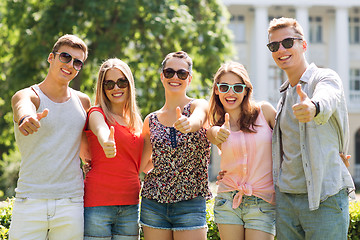 Image showing group of smiling friends showing thumbs up