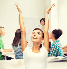 Image showing happy student girl with hands up