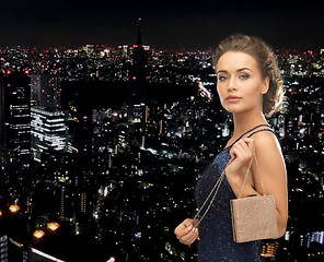 Image showing happy woman in evening dress with small bag