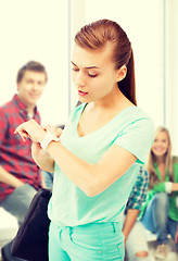 Image showing student girl looking at wristwatch