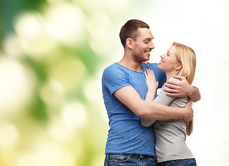 Image showing smiling couple hugging and looking at each other