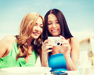 Image showing girls with camera in cafe on the beach