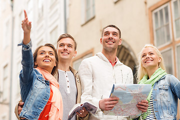 Image showing group of smiling friends with city guide and map