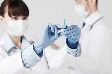 Image showing doctors with syringe