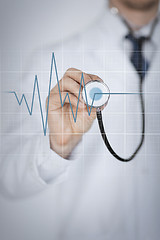 Image showing doctor hand with stethoscope listening heart beat
