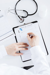 Image showing male doctor writing prescription paper