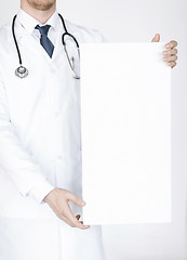 Image showing doctor holding blank white banner