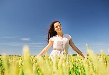 Image showing smiling young woman on cereal field