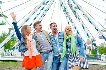 Image showing group of smiling friends waving hands