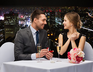 Image showing man proposing to his girlfriend at restaurant