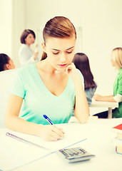 Image showing student girl with notebook and calculator