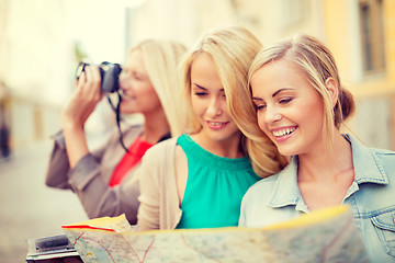 Image showing beautiful blonde women with map in the city