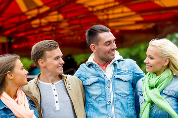 Image showing group of smiling friends in amusement park