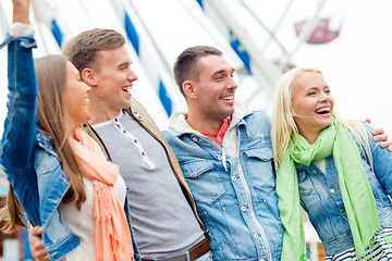 Image showing group of smiling friends in amusement park