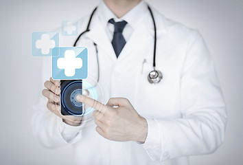 Image showing doctor holding smartphone with medical app