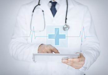 Image showing male doctor holding tablet pc with medical app