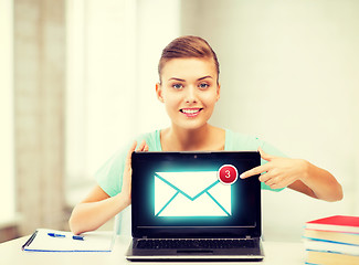 Image showing smiling student girl with laptop at school