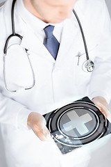 Image showing male doctor holding tablet pc with medical app