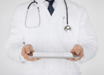 Image showing male doctor holding tablet pc and stethoscope