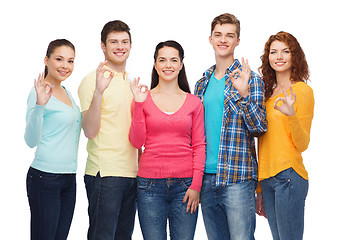 Image showing group of smiling teenagers showing ok sign