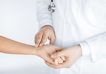 Image showing doctor measuring patient heart beat