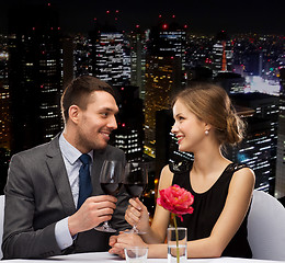 Image showing young couple with glasses of wine at restaurant