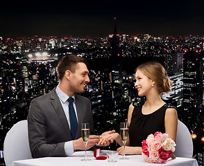 Image showing man proposing to his girlfriend at restaurant