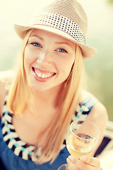 Image showing smiling girl in hat with champagne glass