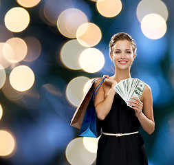 Image showing smiling woman in dress with shopping bags