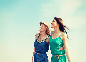 Image showing smiling girls walking on the beach