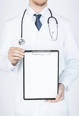 Image showing doctor holding blank white paper