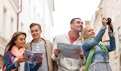 Image showing group of friends with city guide, map and camera