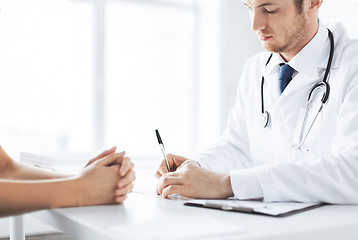 Image showing patient and doctor taking notes