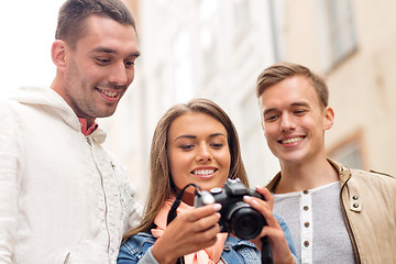 Image showing group of smiling friends with digital photocamera