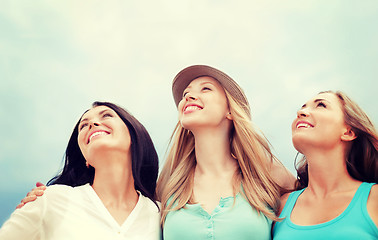 Image showing girls looking up in the sky