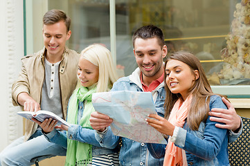 Image showing group of friends with guide and map exploring town