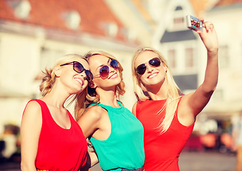 Image showing three beautiful girls taking picture in the city