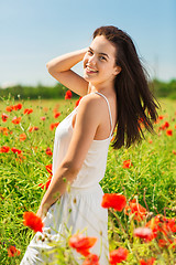 Image showing smiling young woman on poppy field