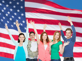 Image showing group of smiling students waving hands