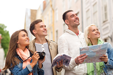 Image showing group of friends with city guide, map and camera