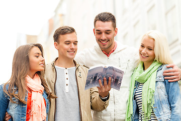 Image showing group of friends with city guide exploring town