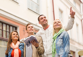 Image showing group of friends with city guide exploring town