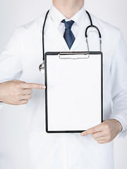 Image showing doctor pointing at blank white paper